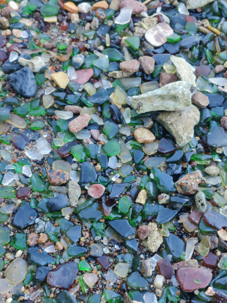 A close-up of colorful sea glass, coral, and pebbles found on Sea Glass Island Aruba.